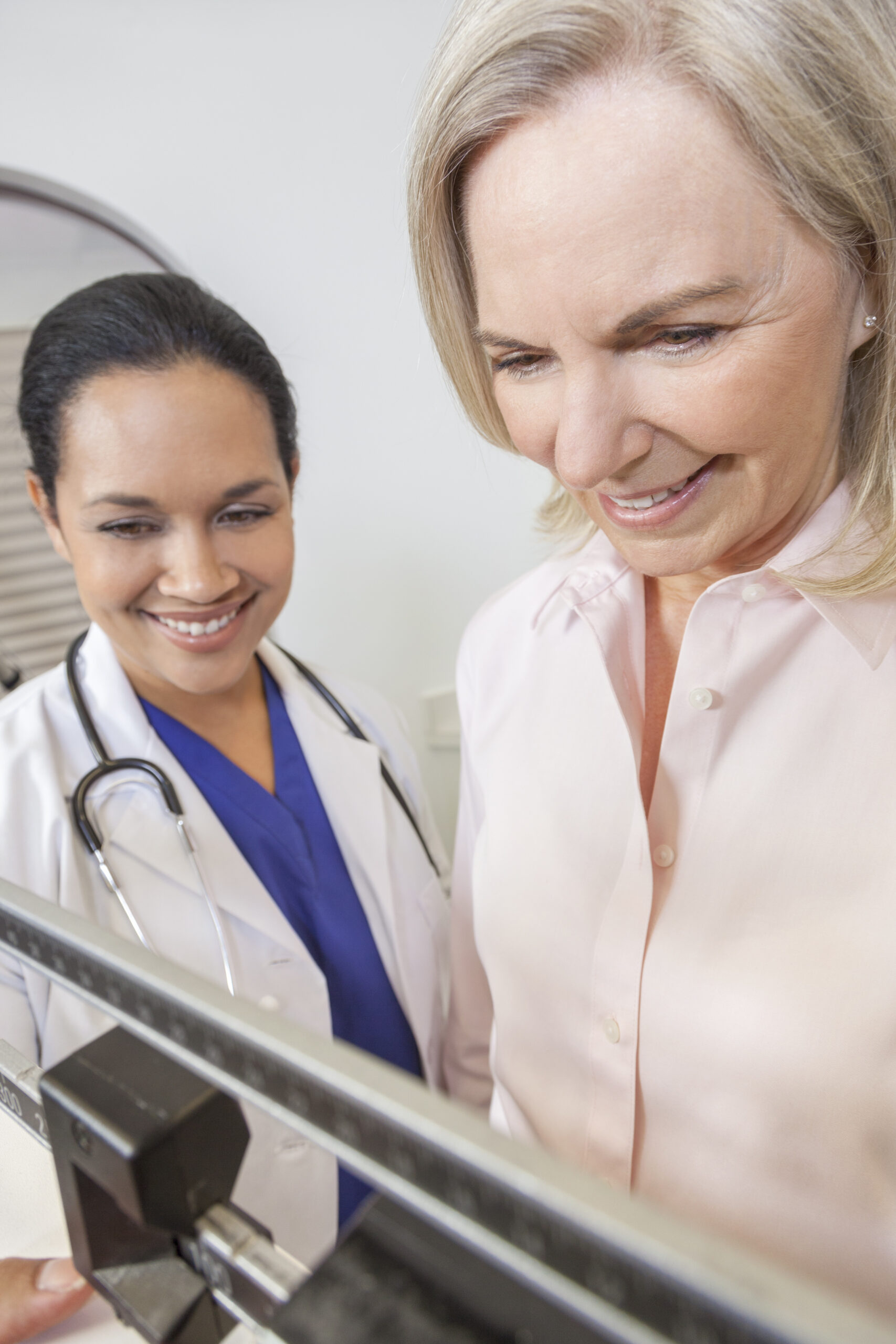 weighing a women at a mobile health clinic